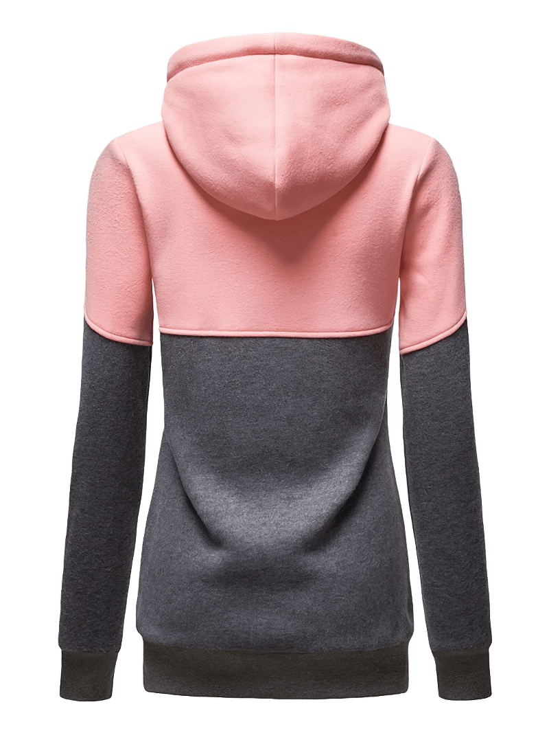 Back view of two-tone zip hoodie in pink and grey, showing casual sporty style with hood and patchwork design.